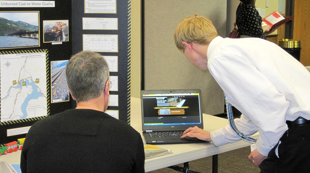 (Courtesy photo)Teagan Dieter, right, presents his information to a judge at the Idaho Water Summit recently at North Idaho College. He earned first-place for his project.