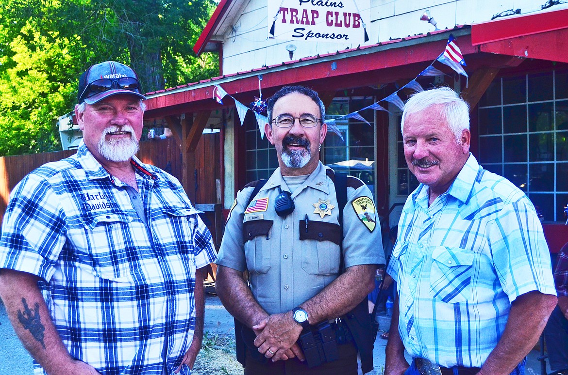 JIM ANDERSON (left), Sheriff Tom Rummel and Joel Waldoch were all in Paradise for the 4th of July celebration. Darin King manned the grill (above right). (Erin Jusseaume/Clark Fork Valley Press)
