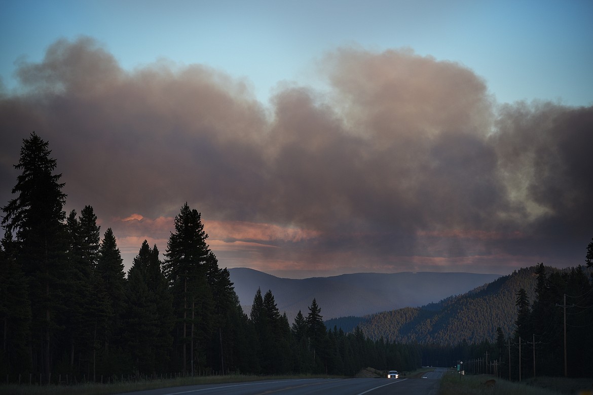 A vehicle heads west on U.S. 2 toward Libby under a heavy blanket of smoke on Sunday night. (Brenda Ahearn/Daily Inter Lake)