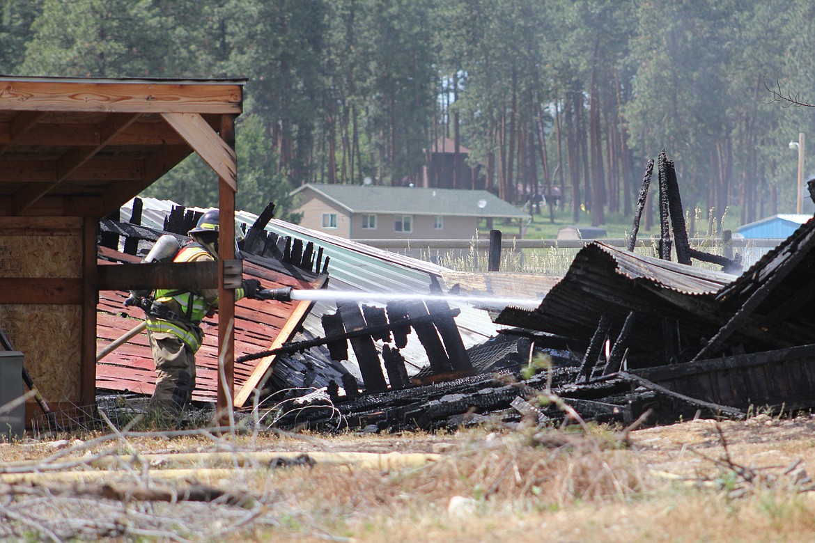The shed was a total loss and the flames melted the siding of a nearby home during a July 4 fire on Brass Lane near Frenchtown. (Kathleen Woodford/Mineral Independent).