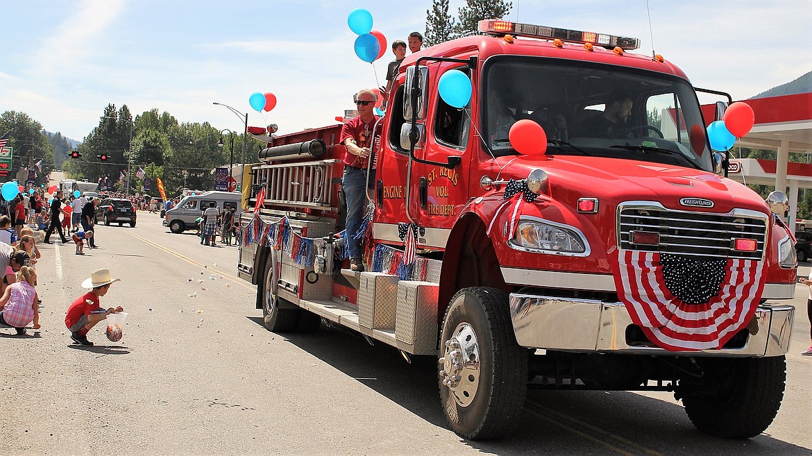 Members of the St. Regis Fire Department toss taffy from their truck. The Department sponsors a large portion of the July 4 celebration in St. Regis.