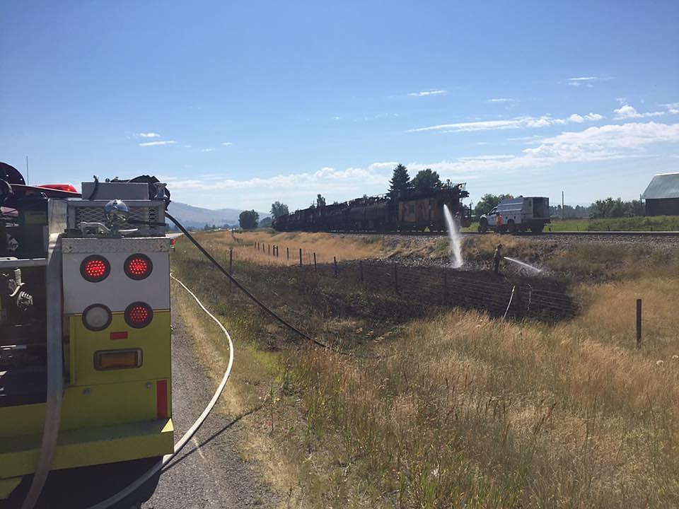 Frenchtown Rural Fire Department responded to several grass fires July 7 and 8 started by a grinding maintenance train. The Montana Rail Link train sprays water on the fires but they were not completely extinguished before they moved on. (Photo courtesy of the Frenchtown Rural Fire Department).
