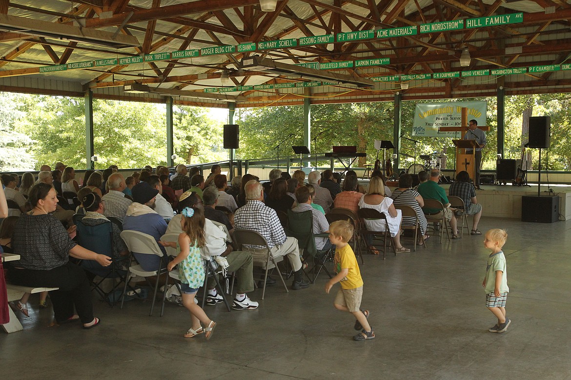 MITCHELL BONDS/Press
Attendees listen to pastor Matt Erickson of Calvary Lutheran Church deliver a sermon at the Community Worship and Prayer Service in the Grand Pavilion in Q&#146;emiln Park at the Post Falls Festival Sunday morning.