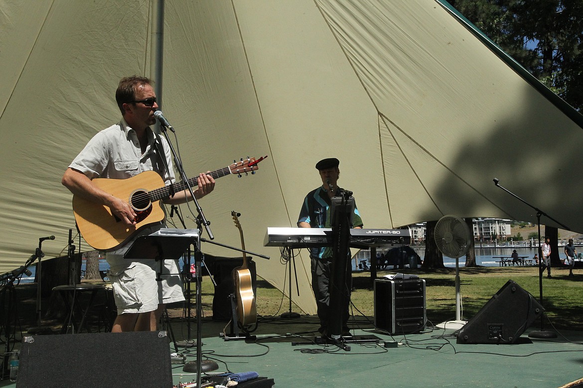 MITCHELL BONDS/Press
Bill Bozly, left, and Blaine Lee play a cover of &#147;Black Water&#148; by the Doobie Brothers as live music for the Post Falls Festival on Sunday. The duo also played with the Blue Mustangs earlier in the festival.