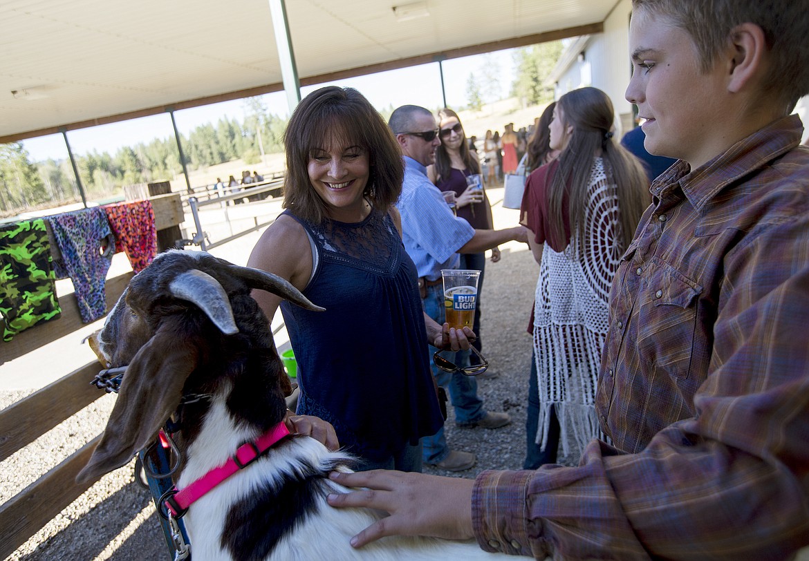 Cooper Ross with 4-H lets Cyndie Wiltsie pet Leo Thursday night at the Rosenberger family&#146;s Rocking R Ranch in Hayden.