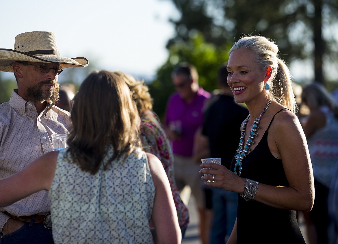 LOREN BENOIT/PressRon and Shelley's daughter-in-law Bre Rosenberger socializes with Katie and Zach Bane Thursday night at the Rosenberger family's Rocking R Ranch in Hayden.