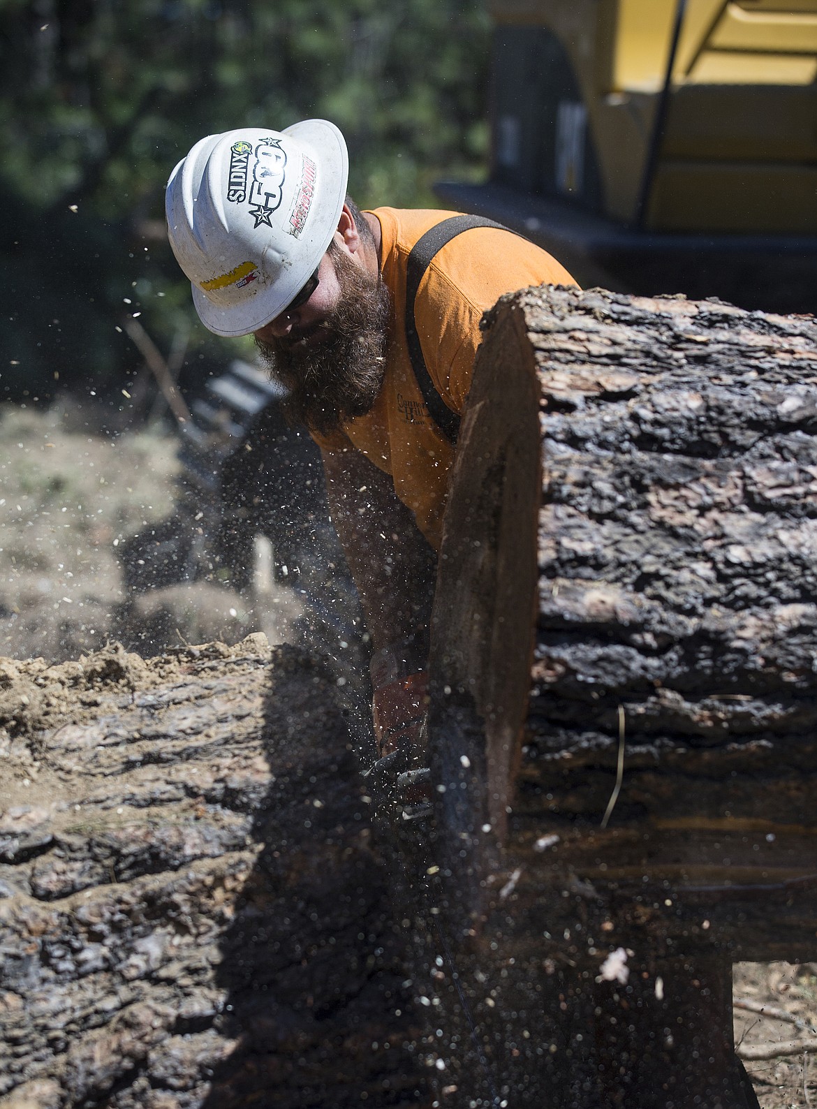 LOREN BENOIT/Press
Barney Higbee with Cannon Hills Industries uses a chain saw to cut a downed tree Monday morning.