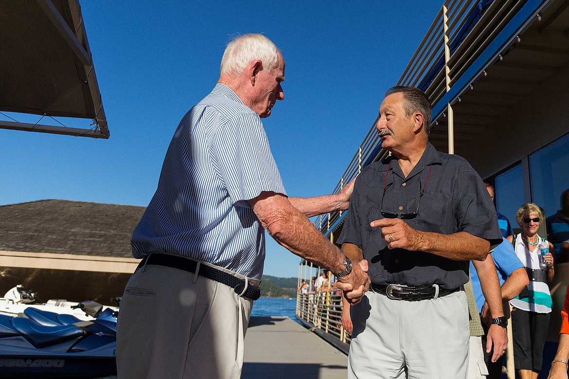 SHAWN GUST/Press File

Duane Hagadone, left, greets Joe Dunlap after guests arrive by cruise boat to the &#147;Celebration in the Gardens&#148; chamber event in July 2015.