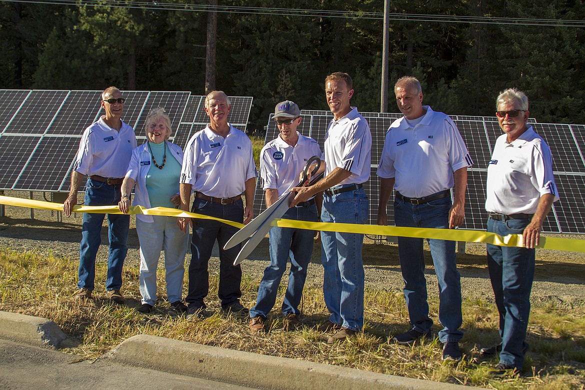 (Photo courtesy MONTANA ELECTRIC COOPERATIVES ASSOCATION)
Northern Lights, Inc., officials use giant scissors to cut through a celebratory ribbon as the utility launches Idaho&#146;s first community solar project on Monday, July 24.