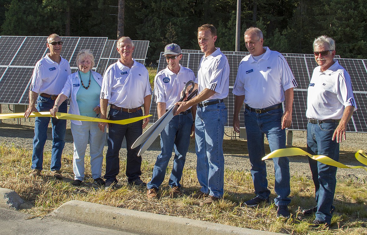 (Photo courtesy MONTANA ELECTRIC COOPERATIVES ASSOCATION)
Northern Lights, Inc., officials use giant scissors to cut through a celebratory ribbon as the utility launches Idaho's first community solar project on Monday, July 24.