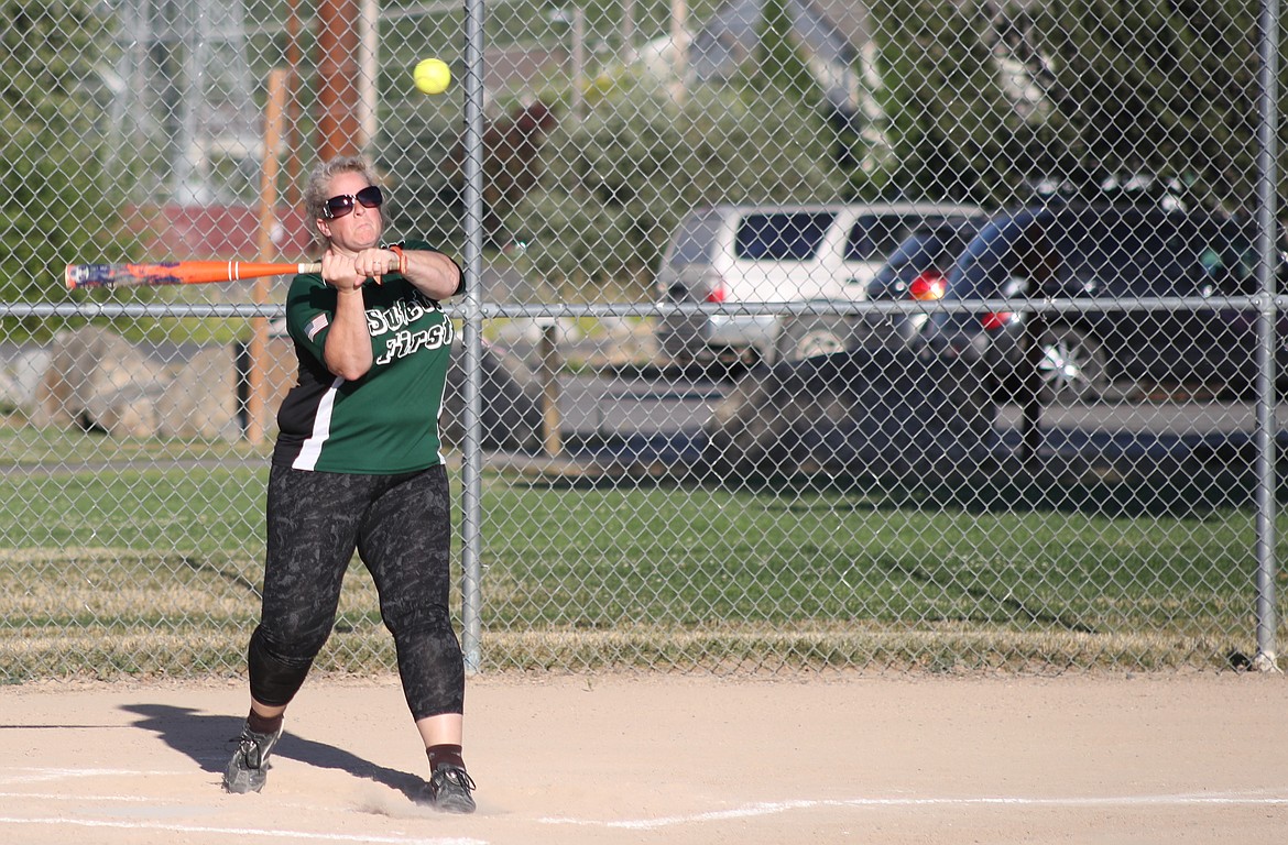 (Photo by ERIC PLUMMER)
Tammy Bell, of Hadley Sentinel, takes a cut at a pitch during Sandpoint City Rec coed softball on Thursday night at sunny Travers Park. Bell&#146;s team beat Idaho Forest Group 7-5, with each team turning a couple of double plays and IFG&#146;s Tommy Groff showing he still has what scout&#146;s call plus speed wheeling around the bases. &#147;All the players are having fun,&#148; said longtime umpire David Broughton. &#147;Kidding each other and helping each other out.&#148; Inland Pump leads the current league standings at 8-1, followed by Spade Construction (6-2), Idaho Forest Group (5-3), Leather and Laces (4-4), Hadley Sentinel (2-6) and Nuttman Welding (0-9).