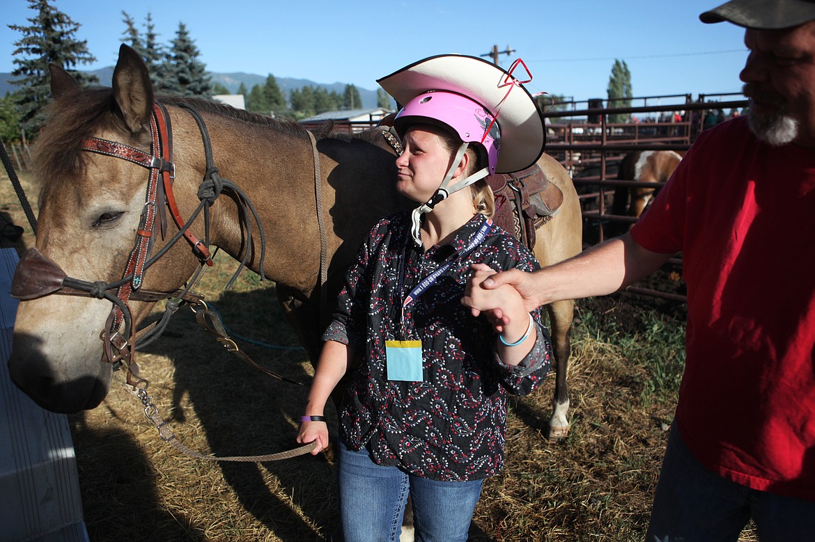 Taylon Halden greets Cricket, her barrel-racing horse for the evening of July 20 at the Blue Moon Rodeo in Columbia Falls. (Mackenzie Reiss/Daily Inter Lake)