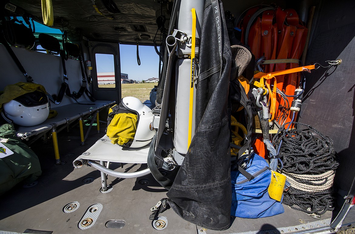 LOREN BENOIT/PressHelmets, cargo nets, a water bucket and other various wildfire equipment rests inside a helitack chopper at the  airtanker base at Coeur d'Alene Airport.