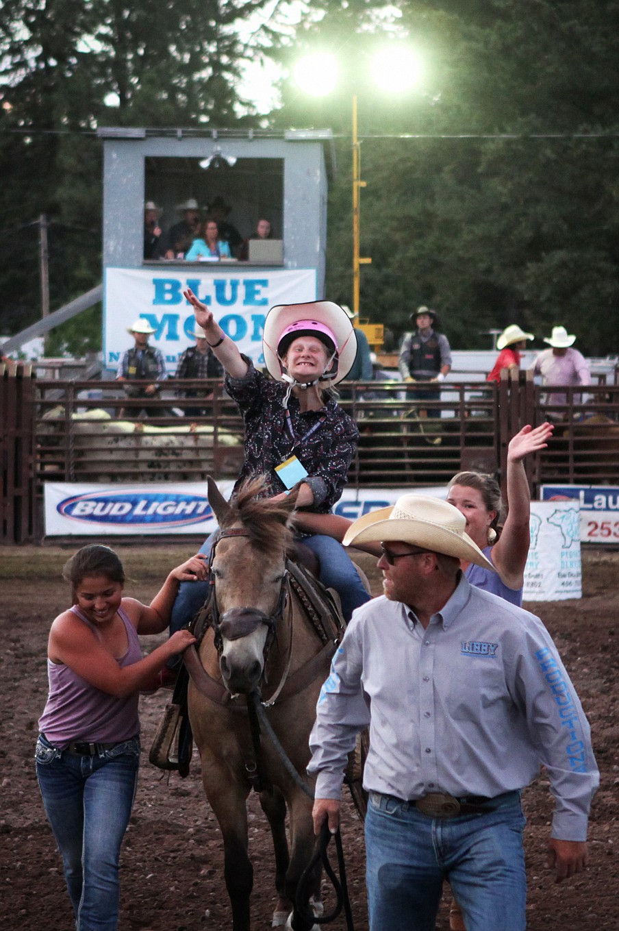 Taylon Halden, of Columbia Falls, gives a wave to the crowd at the Blue Moon Rodeo on July 20. Holden, who lives with cerebral palsy, participated in barrel racing for the first time that night.