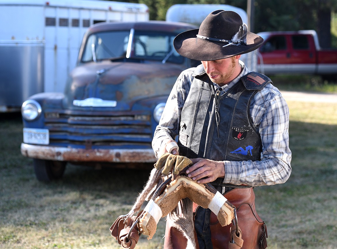 Adam Gluth walks away from his 1951 Chevy with his rigging before the Brash Rodeo Summer Series at the Blue Moon in Columbia Falls on Thursday, July 20, 2017. (Aaric Bryan/Daily Inter Lake)