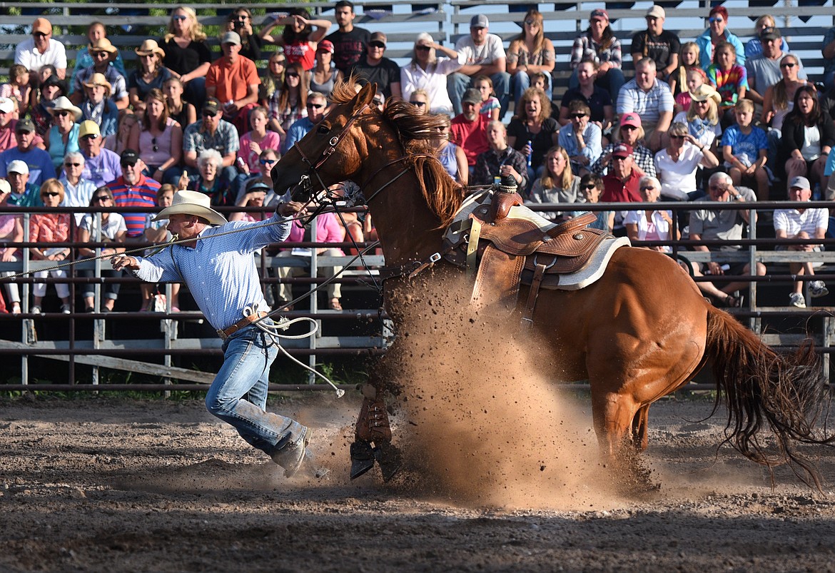 Josh Harris jumps off his horse during tie down roping at the Brash Rodeo Summer Series at the Blue Moon. (Aaric Bryan/Daily Inter Lake)