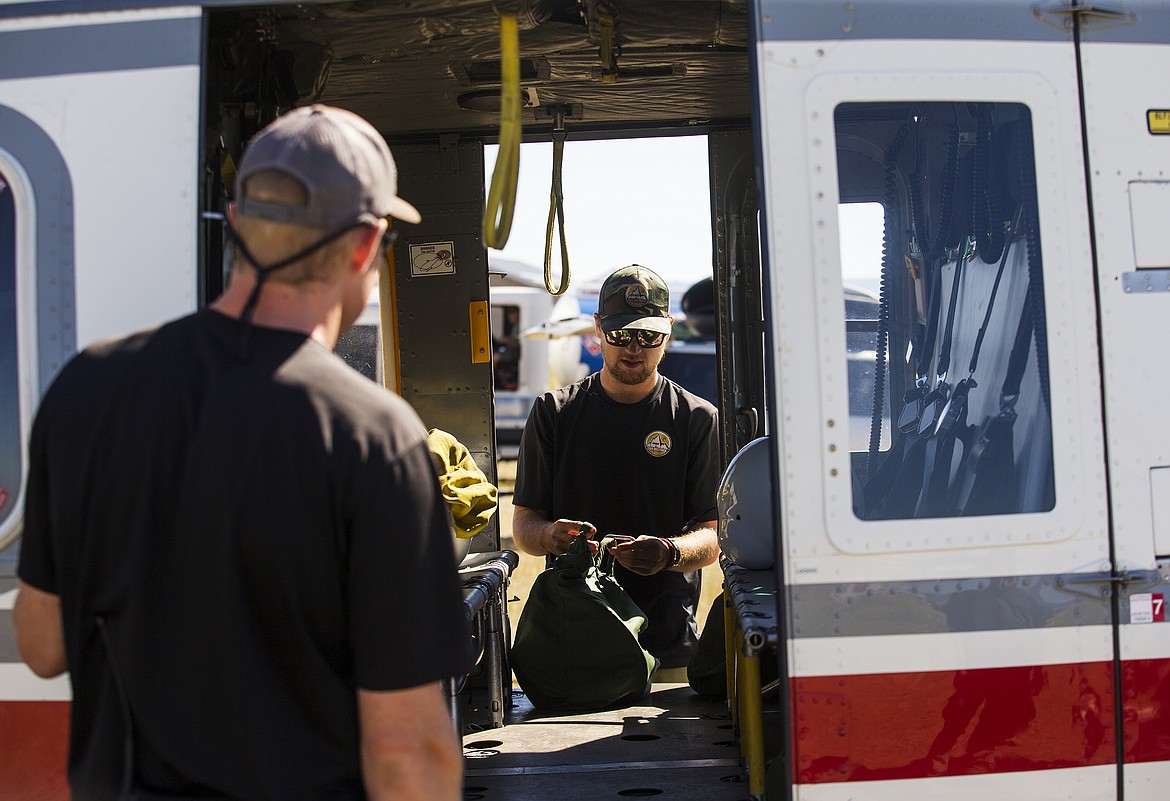 LOREN BENOIT/PressJoe Wren with Coeur d'Alene Helitack places an equipment pack into a helicopter Tuesday morning at the Coeur d'Alene Airport. July through October is considered this region's wildfire season. Countrywide, wildfire seasons typically start in the Southeast, head to the Southwest before starting in the Northwest.