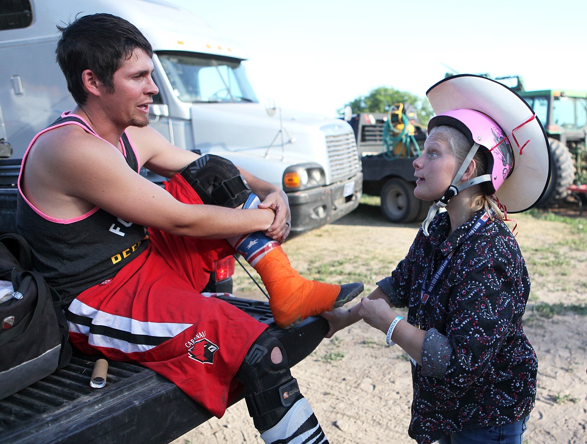 Bullfighter Tyler McDade, of Kalispell, chats with Taylon Halden, of Columbia Falls, prior to the Thursday night rodeo at Blue Moon Arena.