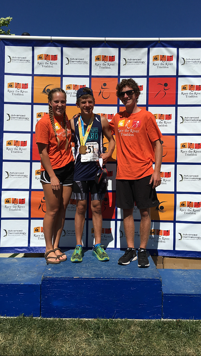 Jim Kinnard, center, Lake City High School junior, completed Race the River&#146;s sprint triathlon on July 23 in Coeur d&#146;Alene. He earned first place in the special needs division. Brianne Gundlach, left, Lake City High senior, was his swim buddy and Jared Meredith, right, Coeur d&#146;Alene High senior, was his run buddy. (Not pictured is Jeff Kinnard and Jim McFeeley, who biked with Jim on his recumbent bike for the 15.7 miles). Jim finished with a time of 2 hours, 41 minutes, and he is the first special needs athlete to participate in this triathlon in the 10 years it has been active.   
Courtesy photo