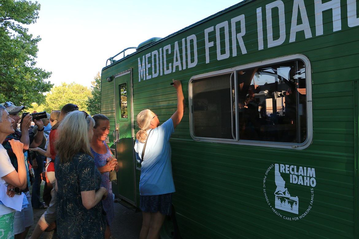 (Photo by MARY MALONE)
Linda Navarre, right, was one of the first, along with several other community members, to sign Reclaim Idaho&#146;s &#147;Medicaid Mobile&#148; as it begins a statewide journey to bring awareness to Idaho&#146;s health care coverage gap.