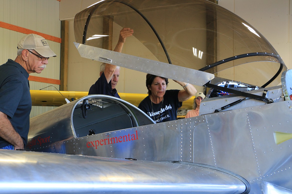 (Photo by MARY MALONE)
Aerobatic pilot Jacquie Warda, right, checks out the plane recently built by students in the North Idaho High School Aerospace program, led by Ken Larson, center, who is the pilot training and academics instructor for the program.