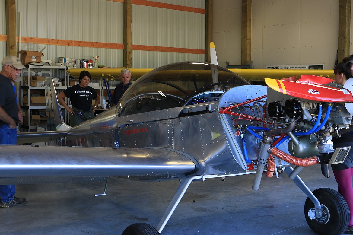 (Photo by MARY MALONE)Aerobatic pilot Jacquie Warda, center, checks out the plane recently built by students in the North Idaho High School Aerospace program.