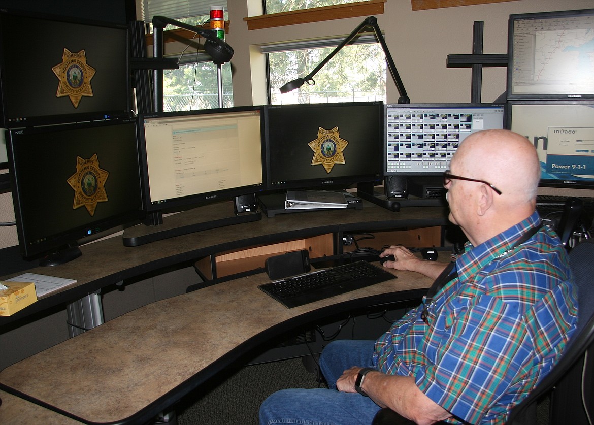 BRIAN WALKER/Press
Bob Kesson, communication services manager at the Kootenai County Sheriff&#146;s Office, is preparing to launch a new emergency notification system that starts Aug. 1. Here, he works at the county&#146;s dispatch center in Coeur d&#146;Alene.