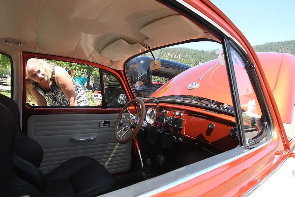 DEVIN HEILMAN/Press
Tana Hoyem took a break from her vendor booth at Bayview's Thunder in the Bay to check out the more than 100 vintage and custom vehicles being shown in the heart of town. Here she examines a sleek cream and orange 1970 Volkswagen Beetle.