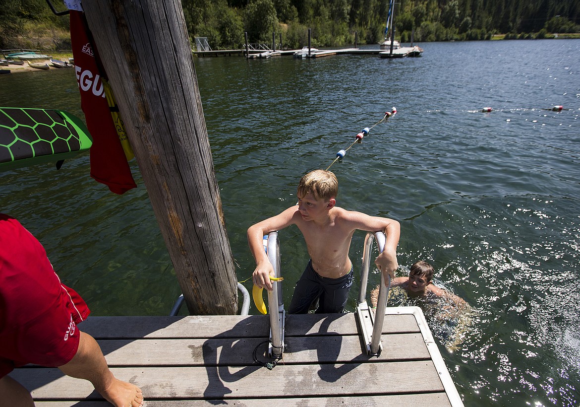 LOREN BENOIT/PressAlden Tryon of Boy Scout troop 498 emerges from the water during a relay activity Friday afternoon at Camp Easton. Boy Scouts played a relay activity where they had to carry the banana to different stations to be quized on scout knowledge.