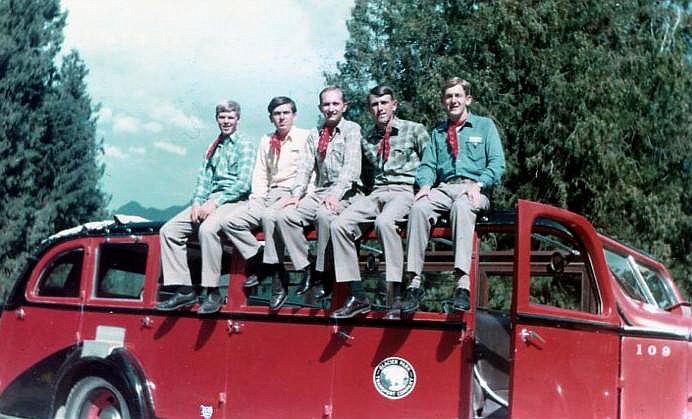 Lake McDonald Lodge bellmen Cliff Hummel, John Pankey, David Curtis, Pete Burgard and James Griffith perch atop a red bus for a photo in 1967.