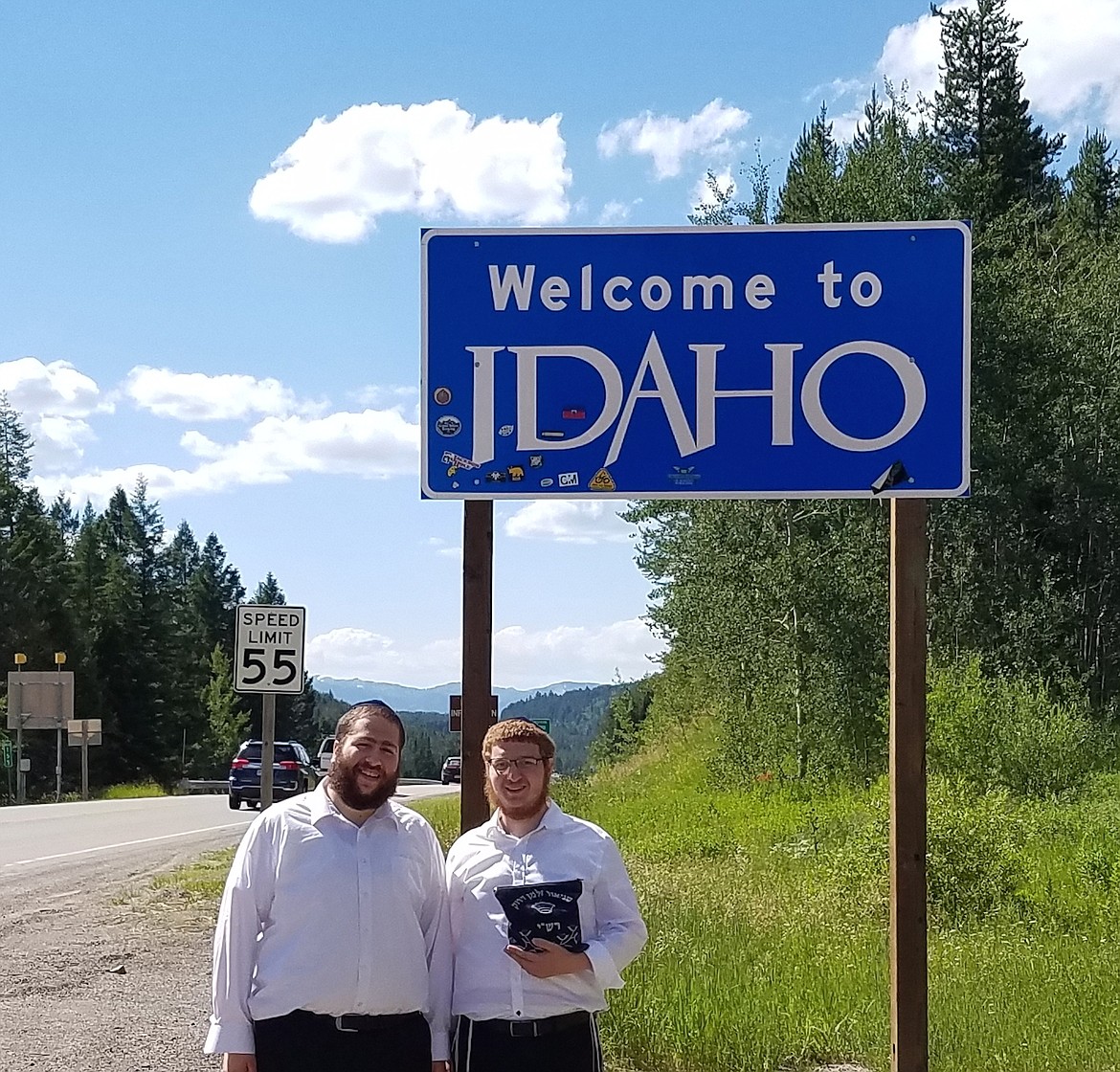 (Photo courtesy ROVING RABBIS)Rabbi Mendal Hertz and Rabbi Schneur Druk get their picture taken along the roadway near a &quot;Welcome to Idaho&quot; sign. The pair will be in Bonner and Boundary counties beginning Sunday evening.