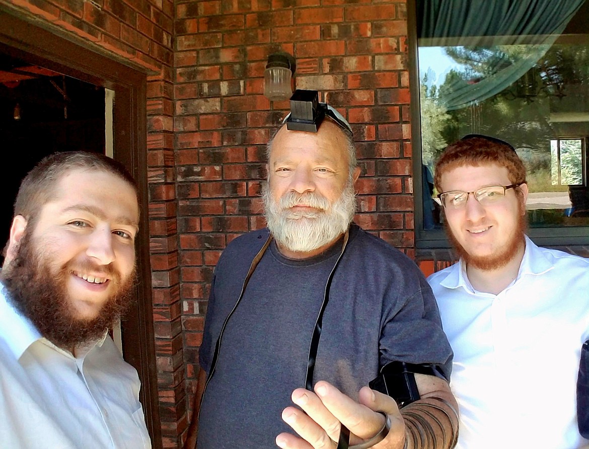 (Photo courtesy ROVING RABBIS)Rabbi Mendal Hertz and Rabbi Schneur Druk get their picture taken  putting on teffilin &#151; a Jewish mitzvah ritual &#151; with some of the people they have met on their travels in Idaho.