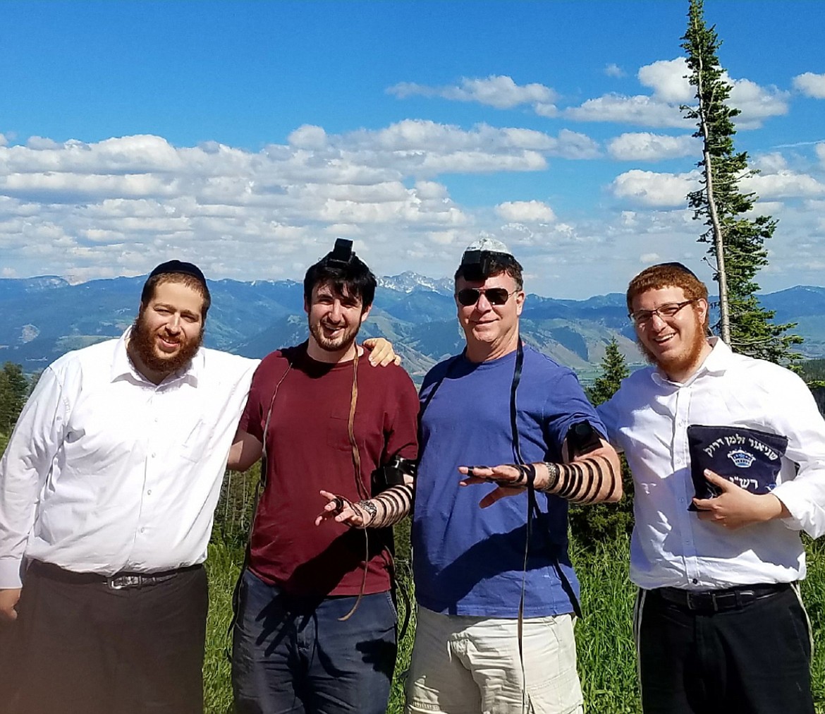 (Photo courtesy ROVING RABBIS)Rabbi Mendal Hertz and Rabbi Schneur Druk get their picture taken  putting on teffilin &#151; a Jewish mitzvah ritual &#151; with some of the people they have met on their travels in Idaho.