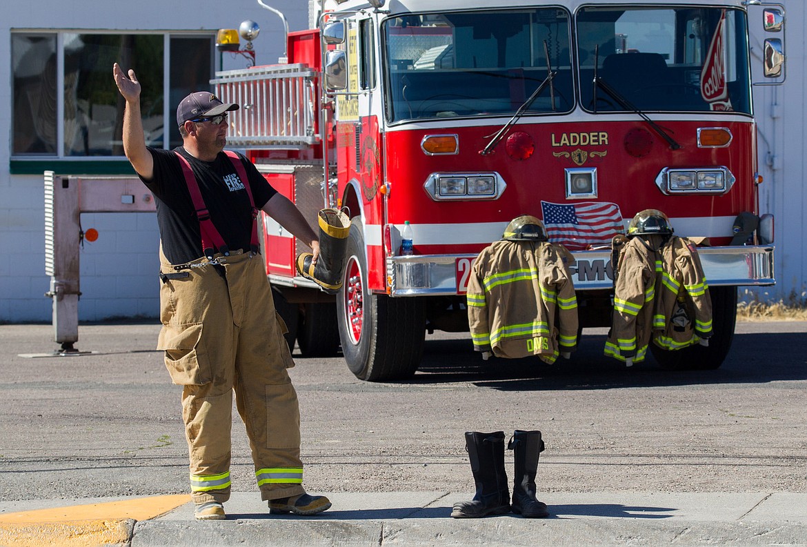 Joe Maroney of Libby Volunteer Fire Department solicits donations from passing motorists in front of Saverite West in Libby Saturday, July 22, 2017. From 10 a.m. to 2 p.m. at that location and in front of Rosauers, firefighters were encouraging passers-by to “fill the boot” to benefit a firefighter who is undergoing treatment for cancer. Fire Chief Tom Wood reported Monday that more than $6,000 was raised. Donations can still be mailed to LVFD, P.O. Box 796, Libby, MT 59923 (John Blodgett/The Western News)