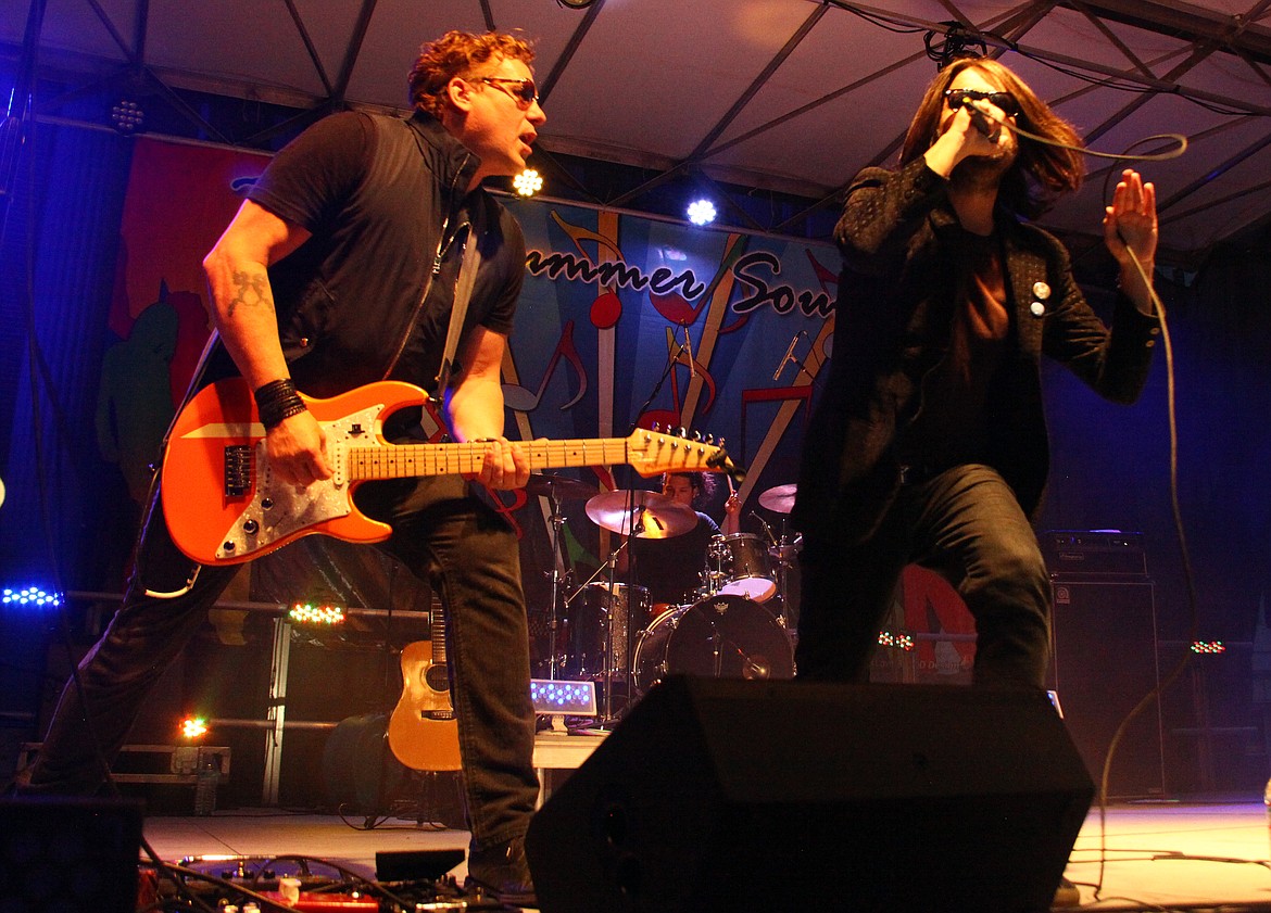 Rodney Harwood/Columbia Basin HeraldXEB guitarist Kevin Cadogan and singer Tony Fredianelli peform during the Basin Sumer Sounds Saturday night in Ephrata.