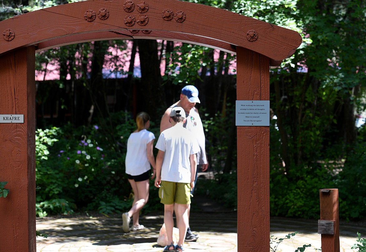 People walk in one of the vortex's found at the House of Mystery. (Aaric Bryan/Daily Inter Lake)