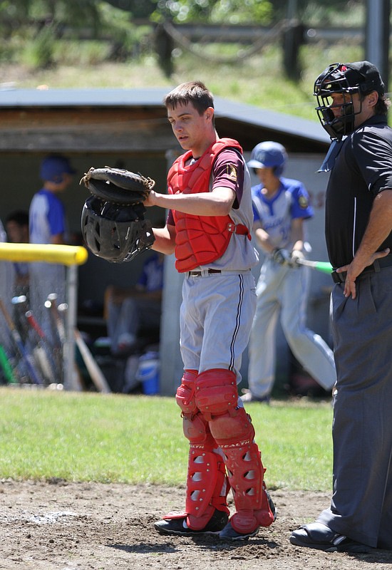 Post 36 catcher Carter Bailey takes a second before putting his mask on.
