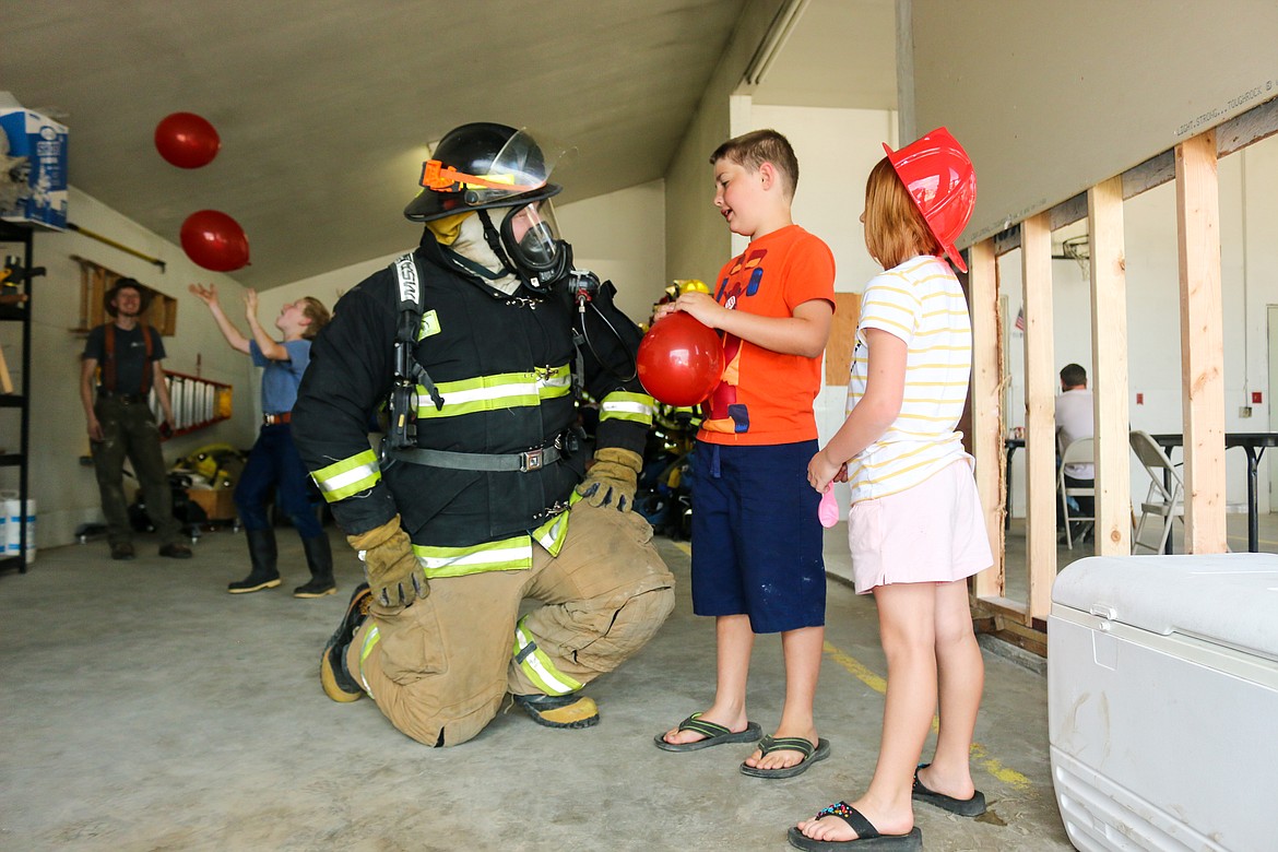 Photo by Mandi Bateman
North Bench Volunteer Firefighter Keanen Hurst donned his full gear to entertain the children.