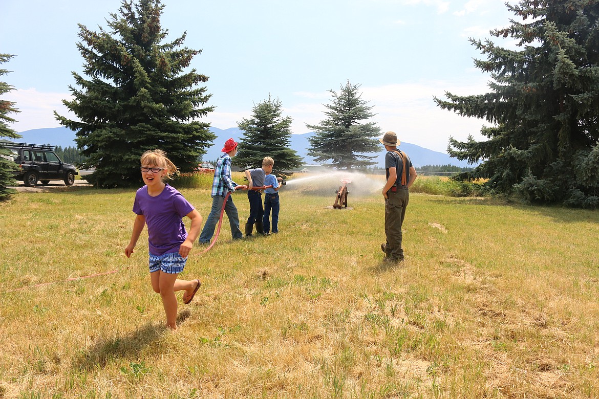 Photo by Mandi Bateman
On a hot summer day, children perfect their skills with a fire hose.