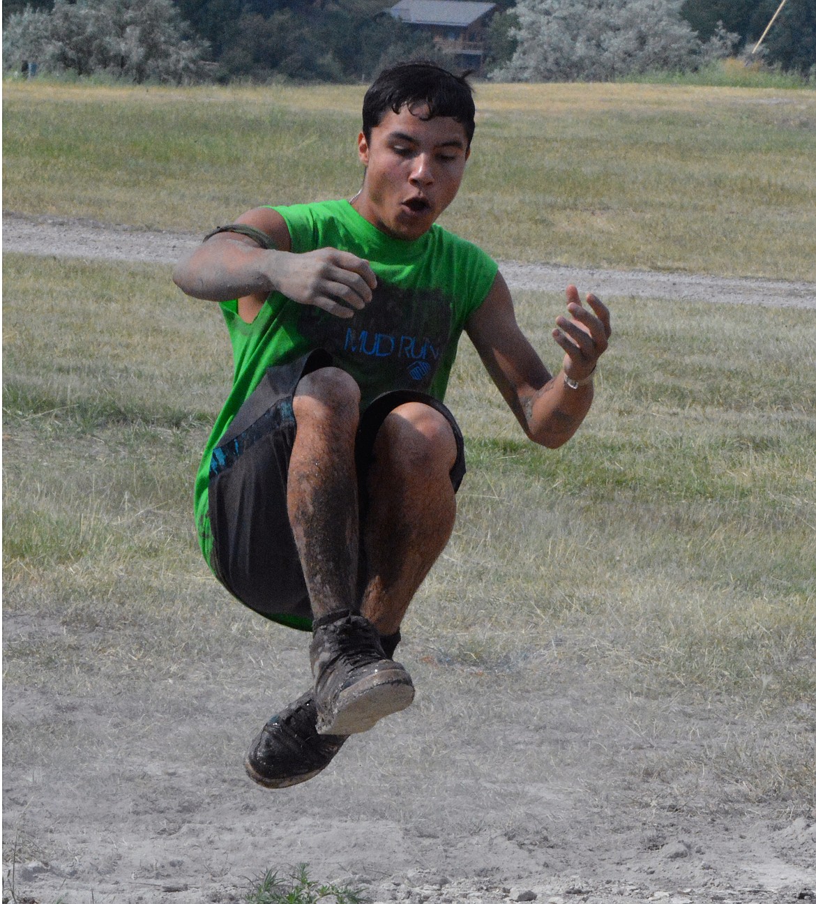 POLSON MUD RUN contestant DeVonte Ramirez levitates over a mud puddle during one of the obstacle courses of the Mud Run. According to Lowell Tyler, organizer of the Mud Run, there were ten times the amount of online registrations then there were last year. (Jason Blasco/Lake County Leader)