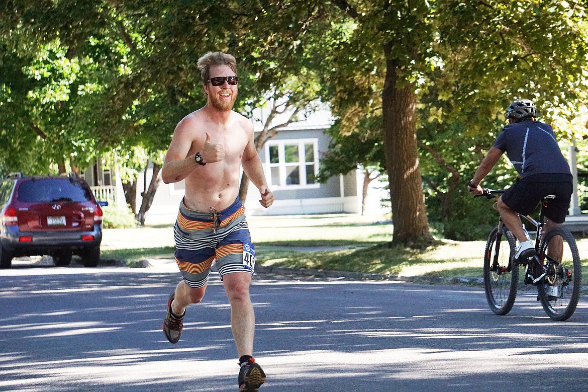 A smiling runner heads toward the finish during the 5K in the Whitefish Lake Triathlon on Sunday.