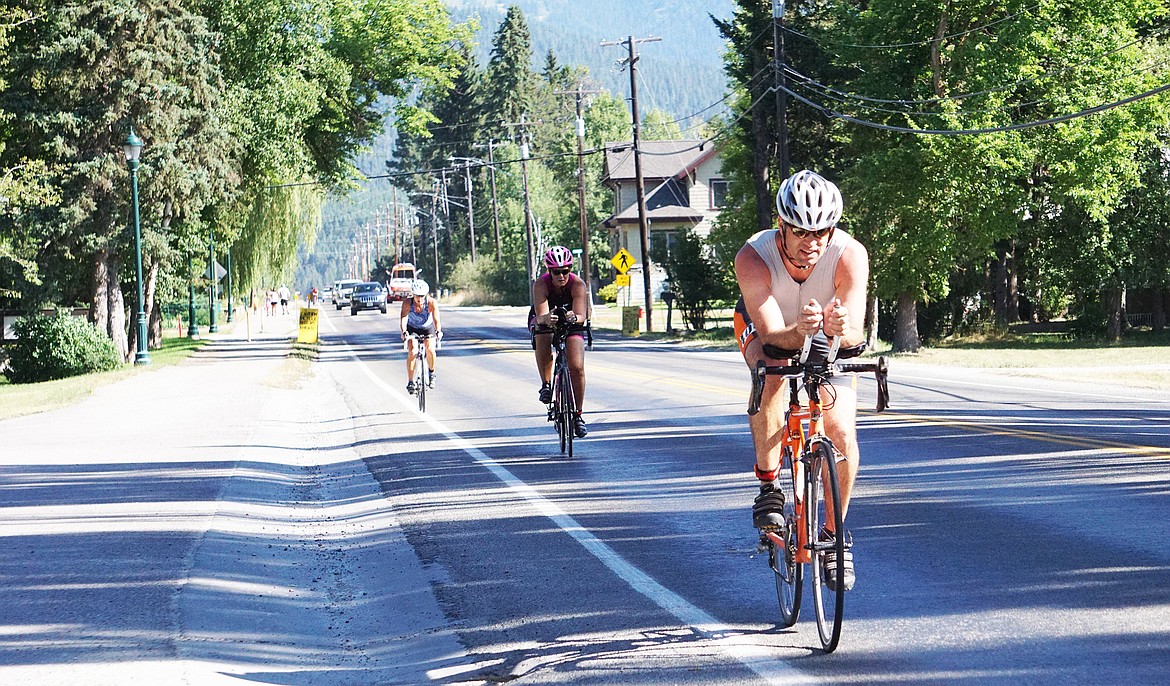 A group of racers pedal down Wisconsin Avenue during the 20K bike race in the Whitefish Lake Triathlon on Sunday.