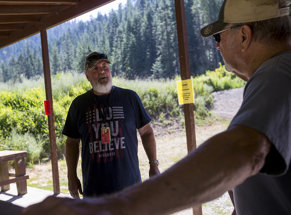 Fernan Rod and Gun Club President John Mahin, left, speaks with gun club member John Bagley Wednesday morning at the shooting range.