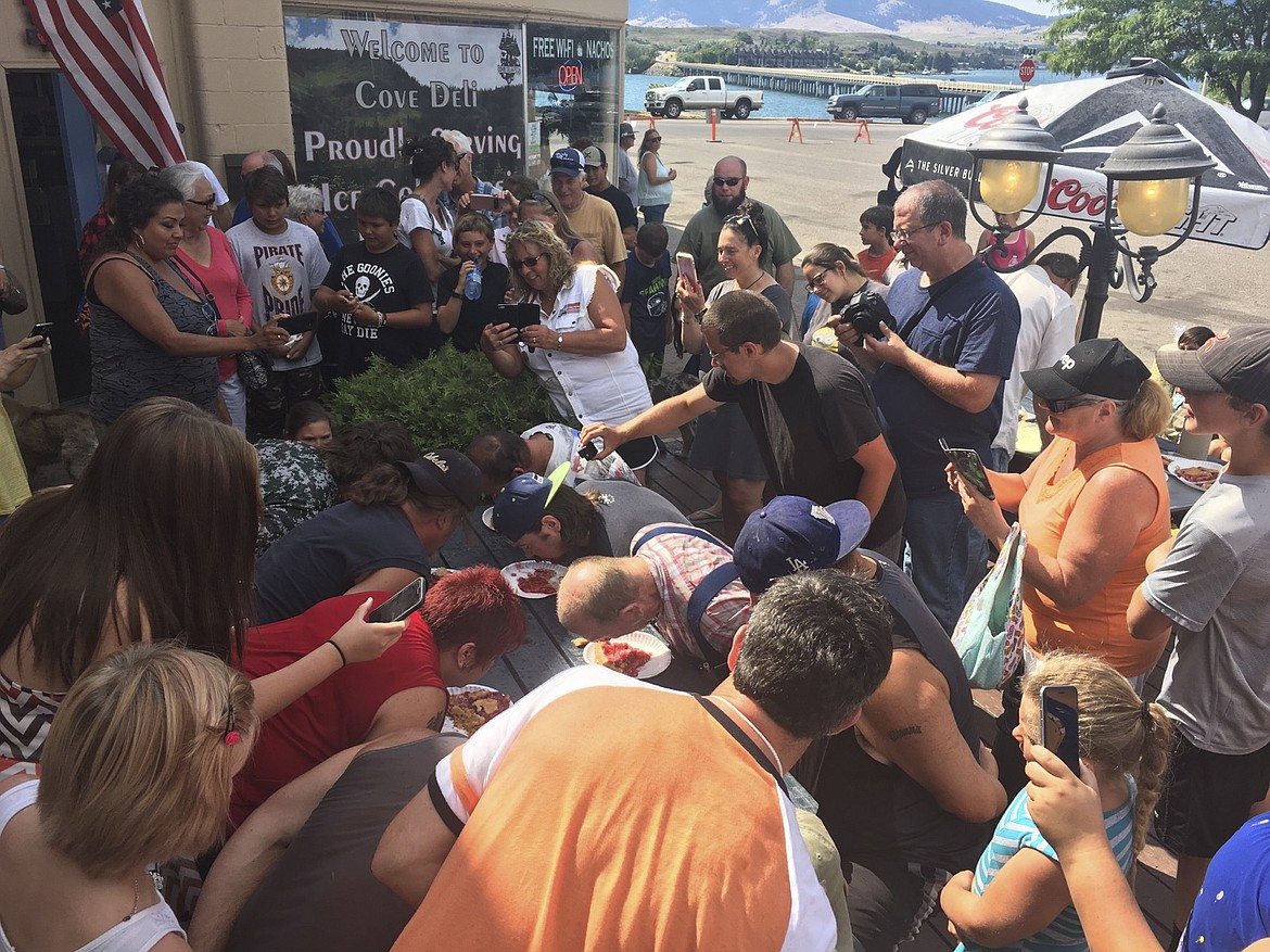 Swarms of people snap photos and take video during the &#147;Cherry Olympics&#148; held in front of the Cove Deli &amp; Pizza in Polson Saturday, as part of the Flathead Cherry Festival.