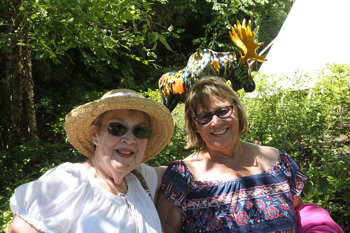 MITCHELL BONDS/Press
Karen Cecil, left, and Jackie &#147;Mrs. Skittles&#148; Skillens got a kick out of the painted moose statue Sunday at the Hagadone Gardens during the 20th annual Garden Tour.