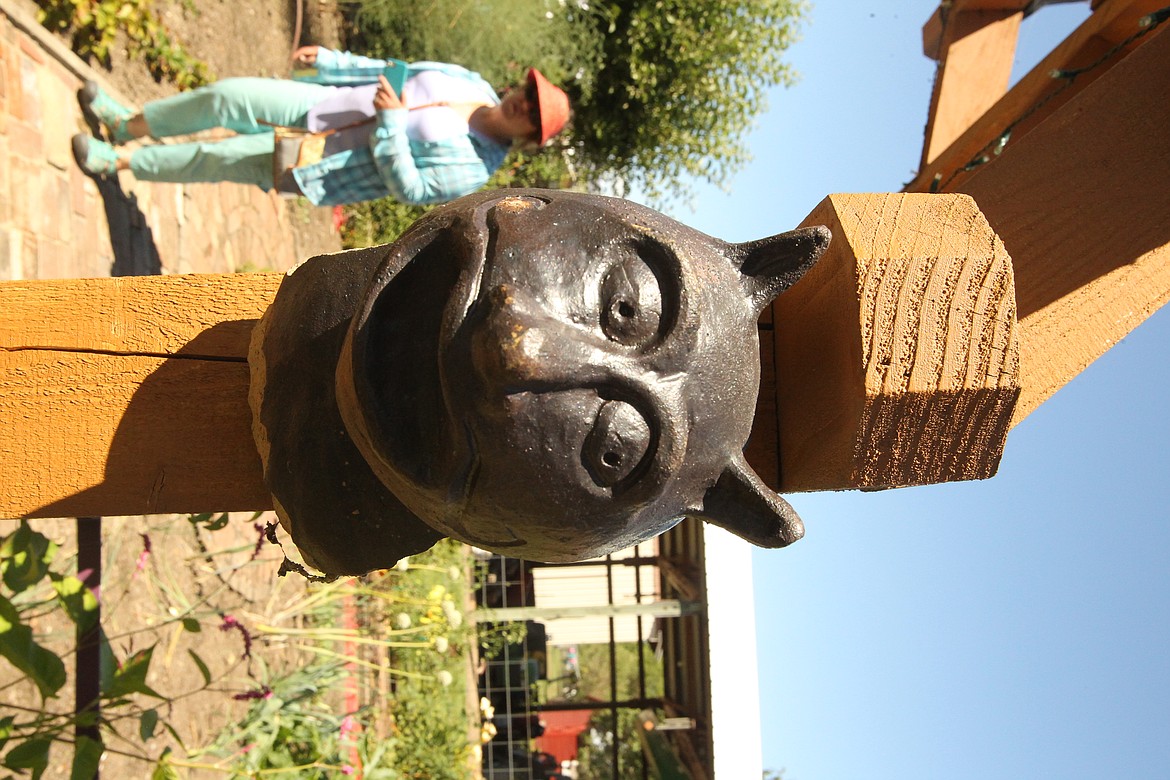 MITCHELL BONDS/Press
An iron bust of a cat&#146;s head adorns one of the arches in Nancy and Steve Heffter&#146;s garden during the 20th annual Garden Tour on Sunday.