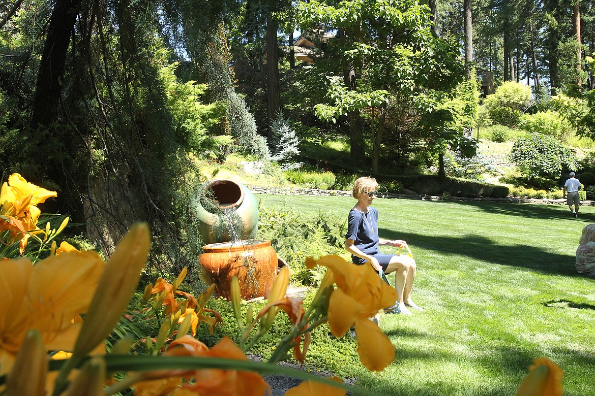 MITCHELL BONDS/Press
Linda Fleming sits by a water feature at the Hagadone Gardens Sunday during the 20th annual Garden Tour.