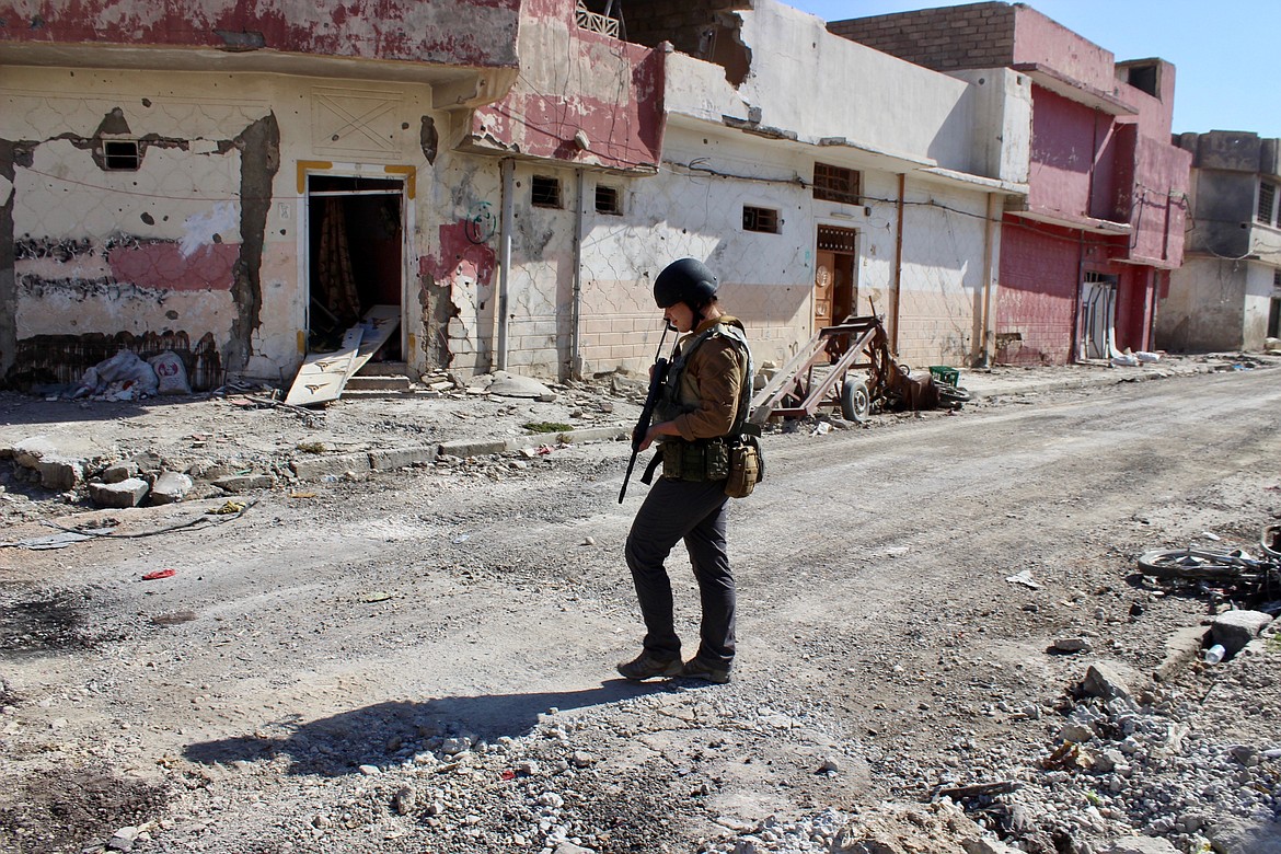 ?Lindsey Westwood, of Coeur d&#146;Alene, walks the streets of Mosul fashioning heavy armor and an AK-47.?
Courtesy photo