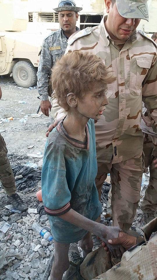 ?Courtesy photo 
A 13-year-old Yazidi boy escorted by soldiers after he&#146;s pulled from the rubble caused by a mortar blast.?