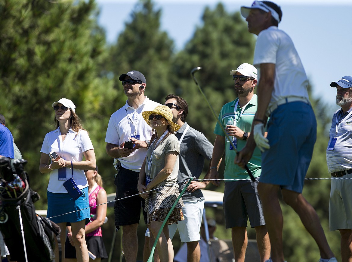 LOREN BENOIT/PressSpectators and fans watch Detlef Schempf's iron shot land on the fairway during The Showcase Saturday afternoon at The Coeur d'Alene Resort Golf Course.